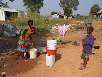 The children are doing daily chores.  The one girl was washing the dishes.